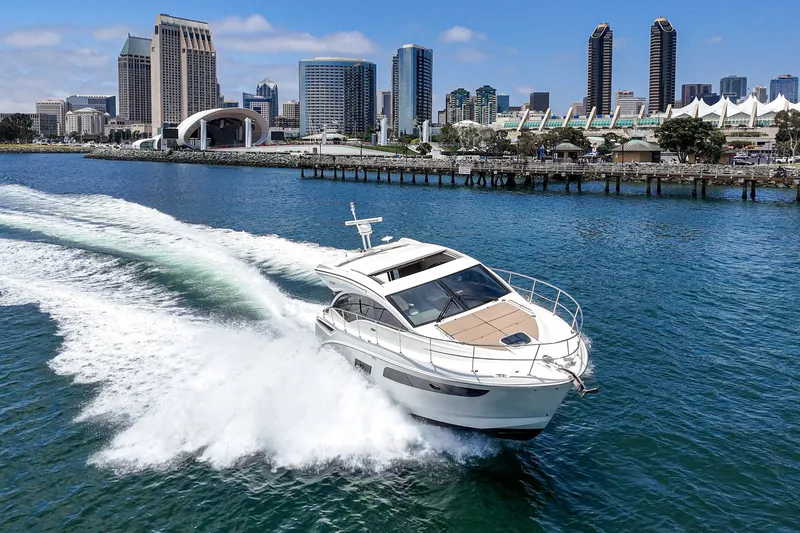 Slide: The Image of 2017 Sea Ray Sundancer 400 cruising in a vibrant city harbor. - 51