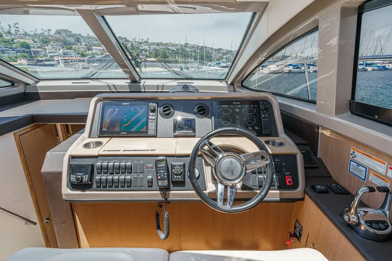 Slide: The Image of Helm of 2017 Sea Ray Sundancer 400 yacht with modern navigation controls and scenic marina view. - 24