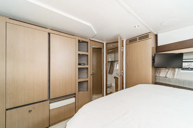 Slide: The Image of Interior of 2017 Sea Ray Sundancer 400 yacht with modern wood cabinetry and compact bathroom. - 32