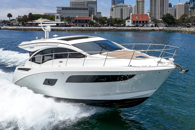 Slide: The Image of 2017 Sea Ray Sundancer 400 cruising in a scenic harbor with city skyline backdrop. - 46
