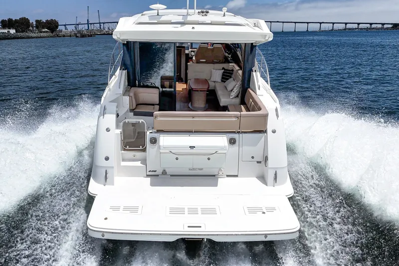 Slide: The Image of 2017 Sea Ray Sundancer 400 yacht cruising on open water, rear view. - 48