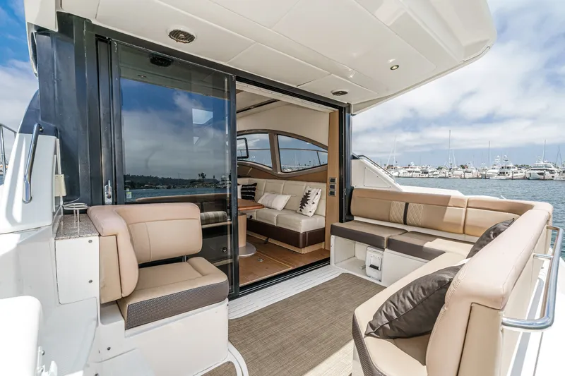 Slide: The Image of Luxurious 2017 Sea Ray Sundancer 400 yacht interior with plush seating and scenic marina view. - 44