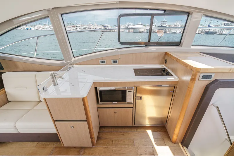 Slide: The Image of Interior of 2017 Sea Ray Sundancer 400 yacht with modern kitchen and scenic marina view. - 18