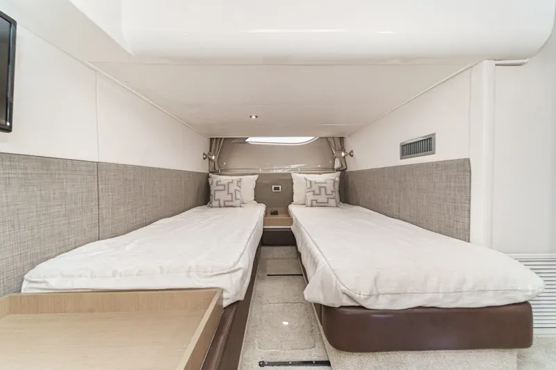 Slide: The Image of 2017 Sea Ray Sundancer 400 cabin with twin beds and modern decor. - 35