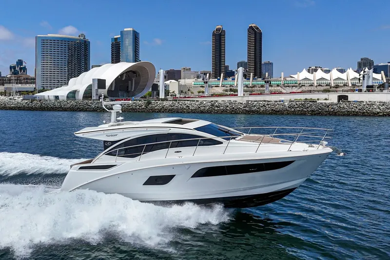 Slide: The Image of 2017 Sea Ray Sundancer 400 yacht cruising near urban waterfront skyline. - 50
