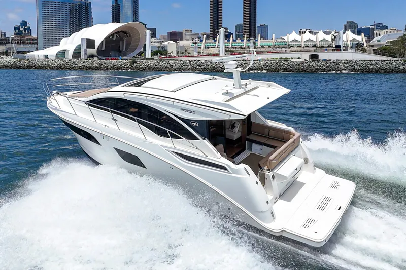 Slide: The Image of 2017 Sea Ray Sundancer 400 yacht cruising near urban waterfront skyline. - 53