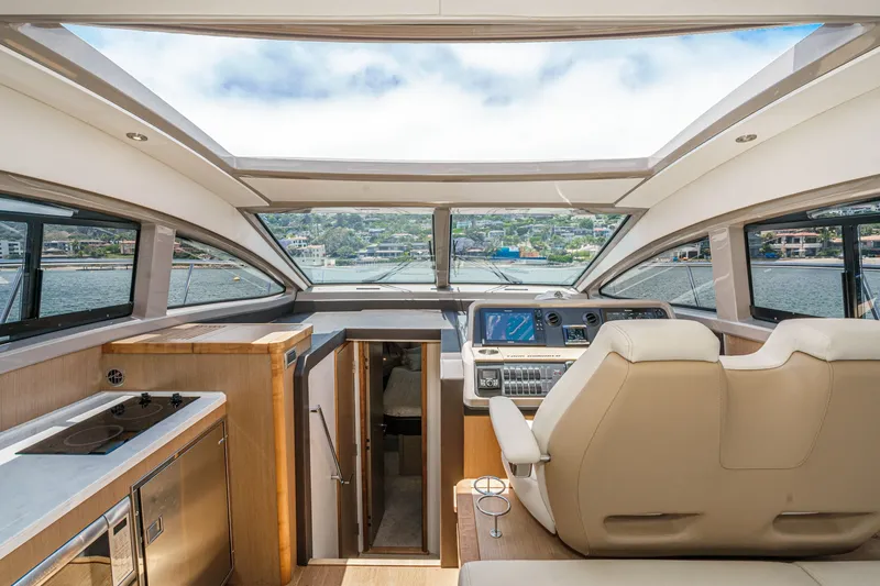 Slide: The Image of Interior view of 2017 Sea Ray Sundancer 400 yacht cockpit with modern controls and seating. - 21