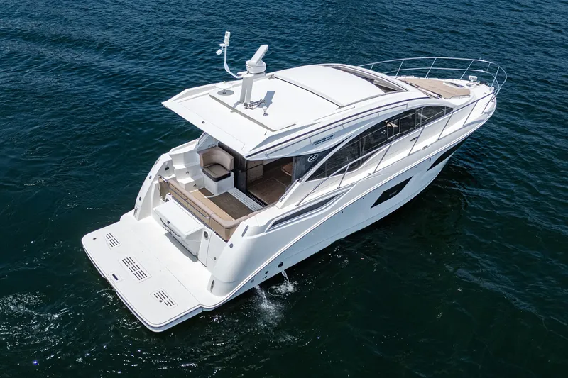 Slide: The Image of 2017 Sea Ray Sundancer 400 yacht cruising on open water, showcasing sleek design and spacious deck. - 71