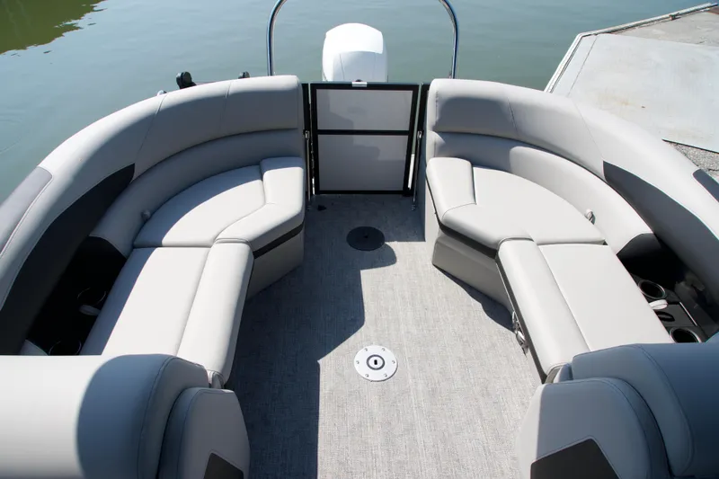Slide: The Image of Luxurious seating on the 2026 Berkshire 22 RFX LE pontoon boat, docked by the water. - 10
