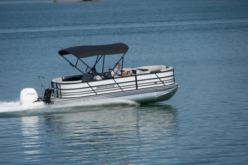 Slide: The Image of 2026 Berkshire 22 RFX LE pontoon boat cruising on a calm lake. - 21