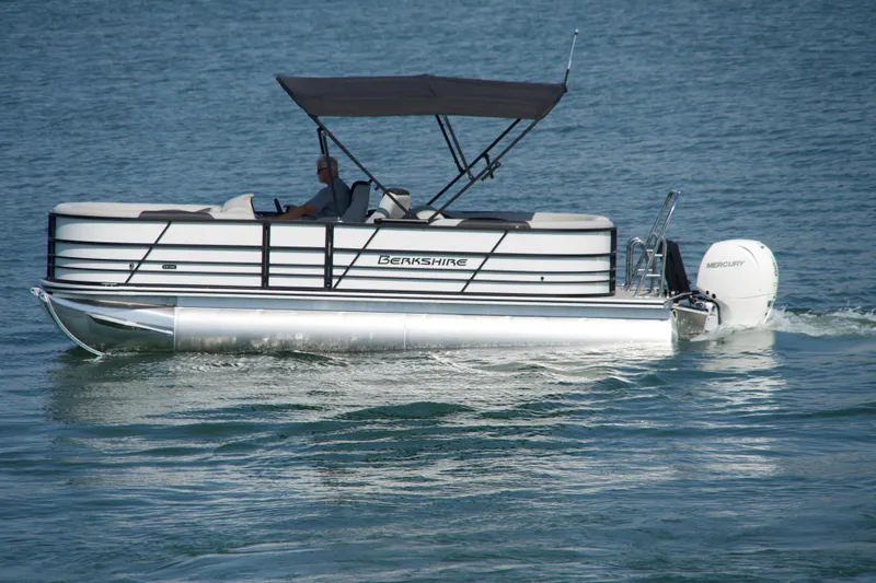 Slide: The Image of 2026 Berkshire 22 RFX LE pontoon boat cruising on a calm lake. - 22