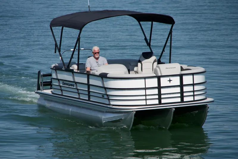 Slide: The Image of 2026 Berkshire 22 RFX LE pontoon boat cruising on a calm lake. - 3