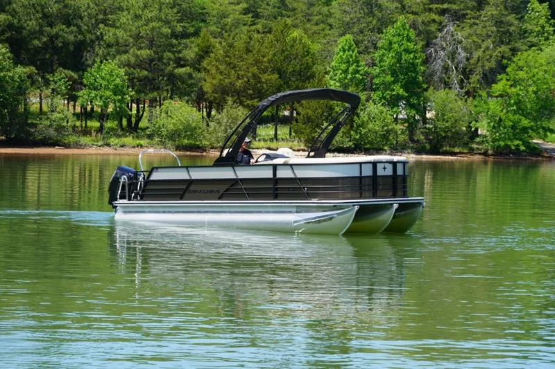 Slide: The Image of 2026 Berkshire 22 UL CTS pontoon boat cruising on a serene lake. - 1