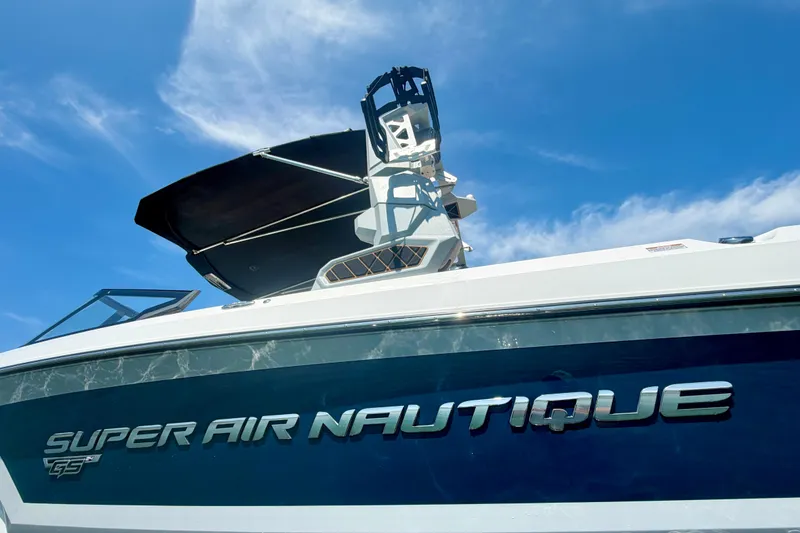 Slide: The Image of 2022 Nautique Super Air Nautique GS24 boat under clear blue sky. - 10