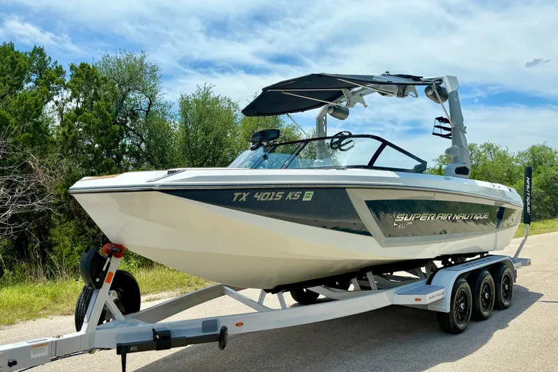 Slide: The Image of 2022 Nautique Super Air Nautique GS24 boat on trailer, parked on a sunny day. - 13