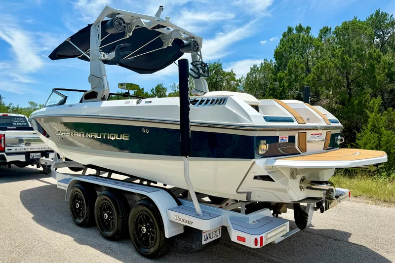 Slide: The Image of 2022 Nautique Super Air Nautique GS24 boat on trailer, parked outdoors. - 14