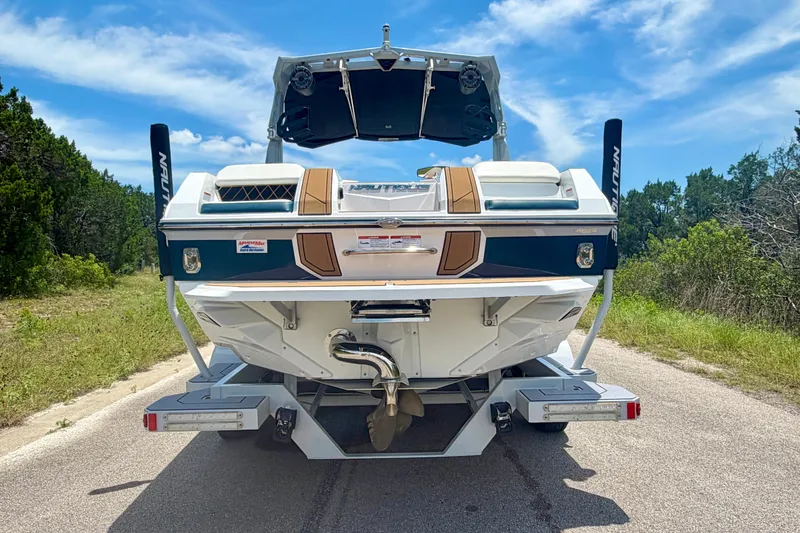 Slide: The Image of 2022 Nautique Super Air Nautique GS24 boat on a road, rear view. - 15