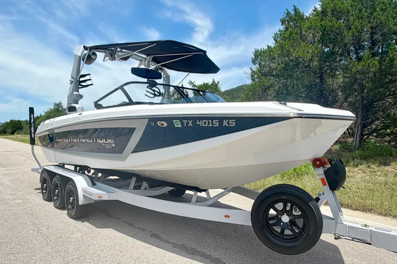 Slide: The Image of 2022 Nautique Super Air Nautique GS24 boat on trailer, parked on roadside. - 17
