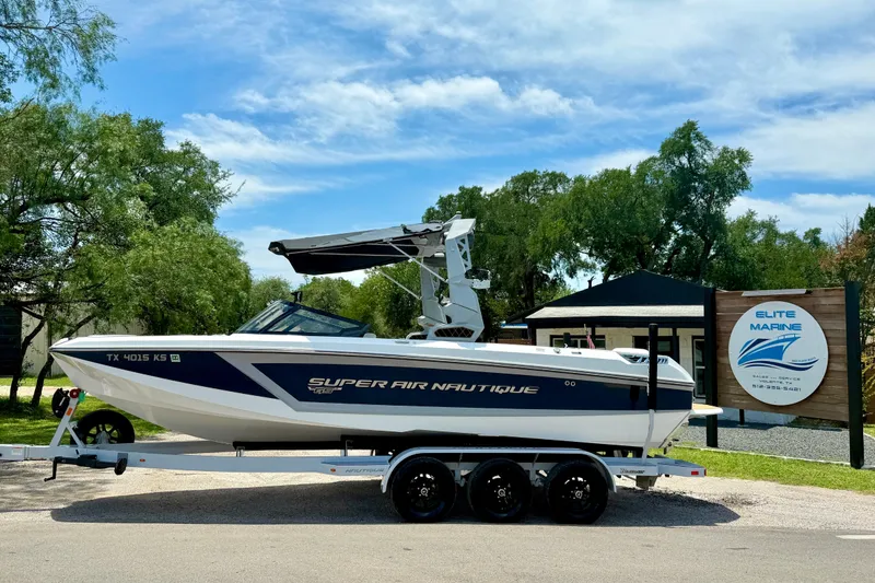 Slide: The Image of 2022 Nautique Super Air Nautique GS24 boat on trailer at Elite Marine dealership. - 2
