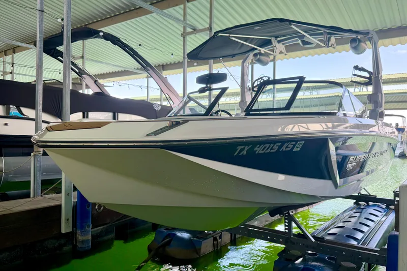 Slide: The Image of 2022 Nautique Super Air Nautique GS24 boat docked in a covered marina. - 20