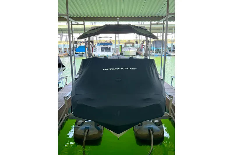 Slide: The Image of 2022 Nautique Super Air Nautique GS24 covered in a marina dock. - 25
