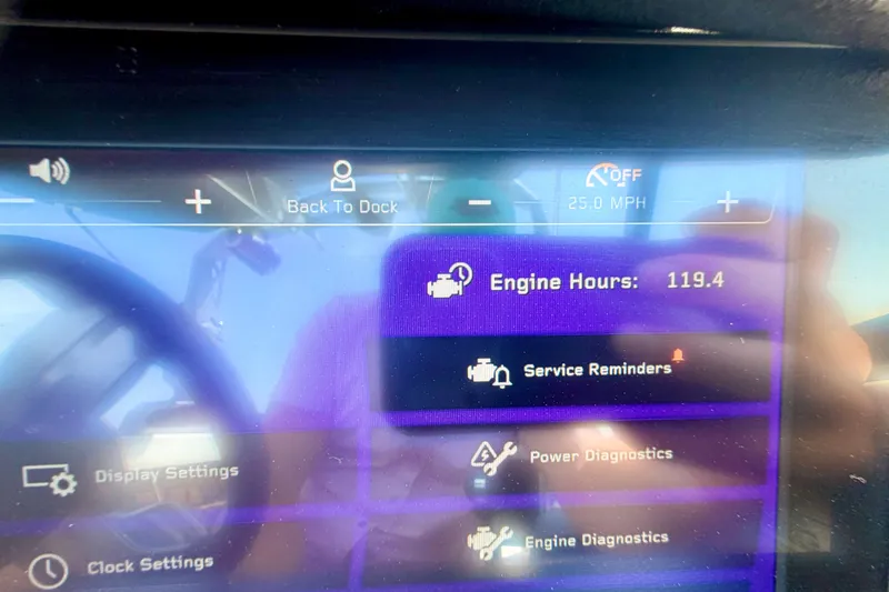 Slide: The Image of Dashboard of 2022 Nautique Super Air Nautique GS24 showing engine hours and service reminders. - 27