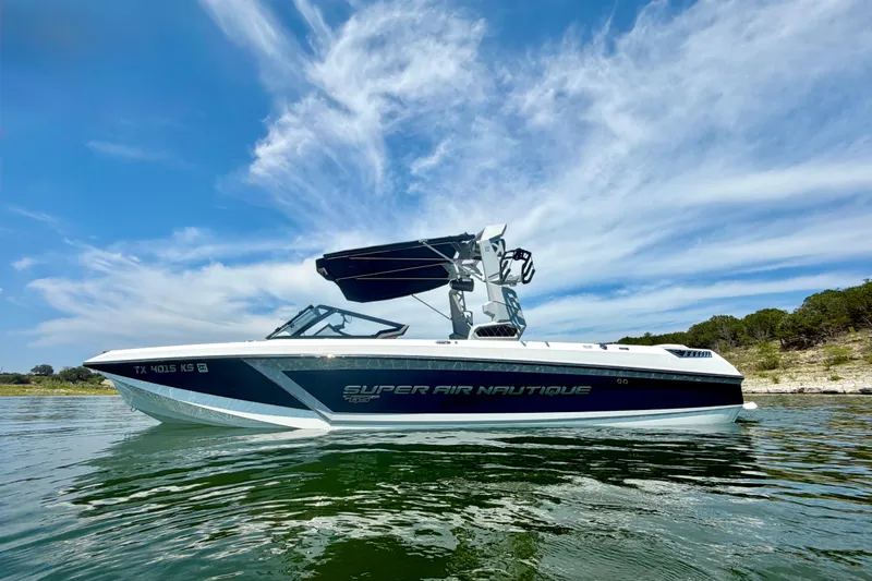 Slide: The Image of 2022 Nautique Super Air Nautique GS24 boat on water under blue sky. - 3