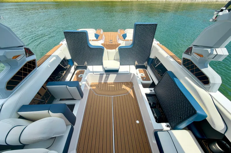 Slide: The Image of 2022 Nautique Super Air Nautique GS24 interior with luxurious seating and teak flooring. - 32