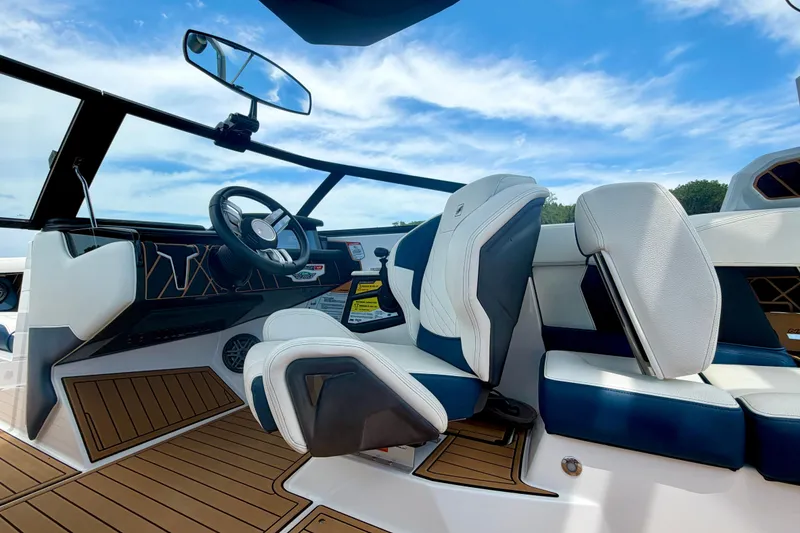 Slide: The Image of 2022 Nautique Super Air Nautique GS24 interior with sleek design and modern steering wheel. - 34