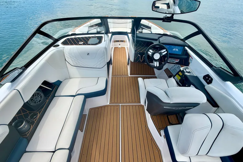 Slide: The Image of 2022 Nautique Super Air Nautique GS24 interior with luxurious seating and modern dashboard. - 37