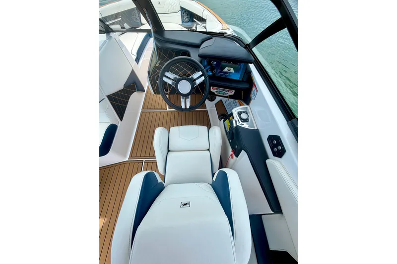 Slide: The Image of Interior view of 2022 Nautique Super Air Nautique GS24 boat cockpit with modern controls. - 38