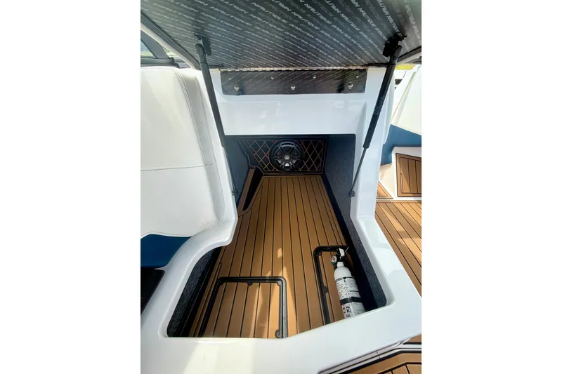 Slide: The Image of 2022 Nautique Super Air Nautique GS24 interior storage with teak flooring and fire extinguisher. - 39