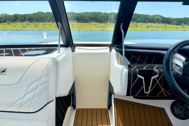 Slide: The Image of Interior view of 2022 Nautique Super Air Nautique GS24 boat with lake backdrop. - 40