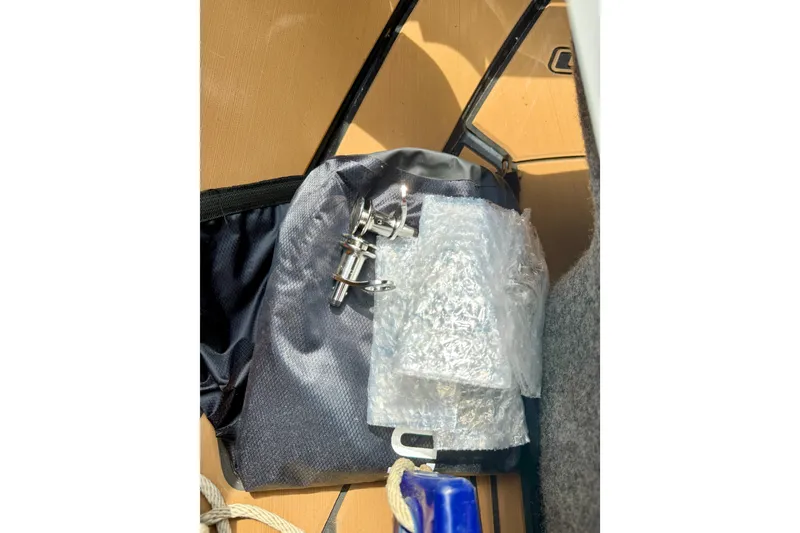 Slide: The Image of Storage compartment in a 2022 Nautique Super Air Nautique GS24 boat with accessories. - 42