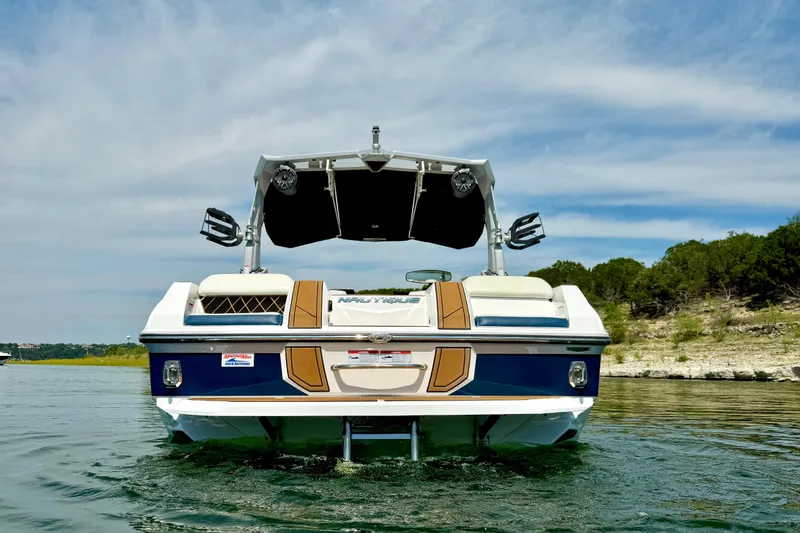 Slide: The Image of 2022 Nautique Super Air Nautique GS24 boat on water, rear view. - 5