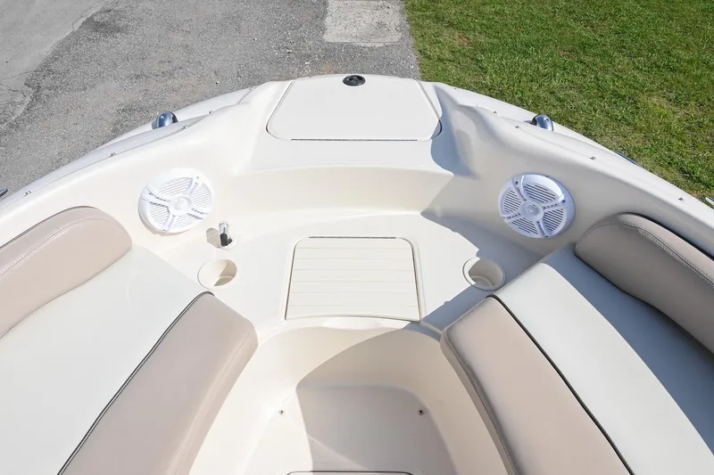 Slide: The Image of Bow seating area of 2002 Sea Ray 240 Sundeck with speakers and cup holders. - 18