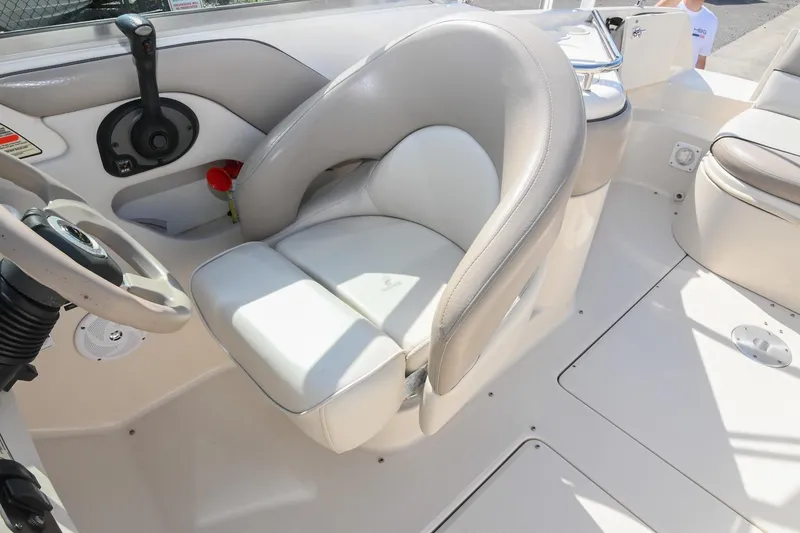 Slide: The Image of Interior of a 2002 Sea Ray 240 Sundeck boat, featuring a comfortable captain's chair. - 19