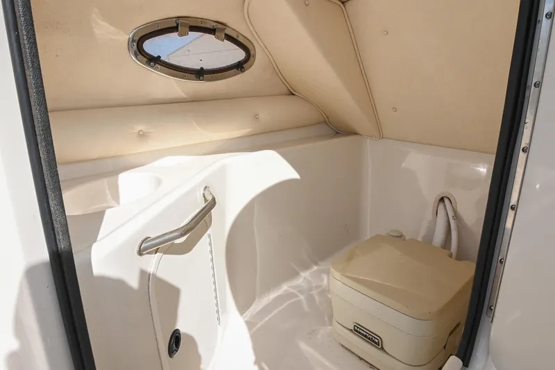 Slide: The Image of Interior of a 2002 Sea Ray 240 Sundeck boat with a compact marine toilet. - 20