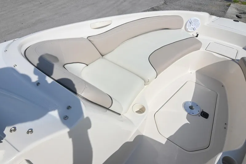 Slide: The Image of 2002 Sea Ray 240 Sundeck interior with beige seating and speaker detail. - 21