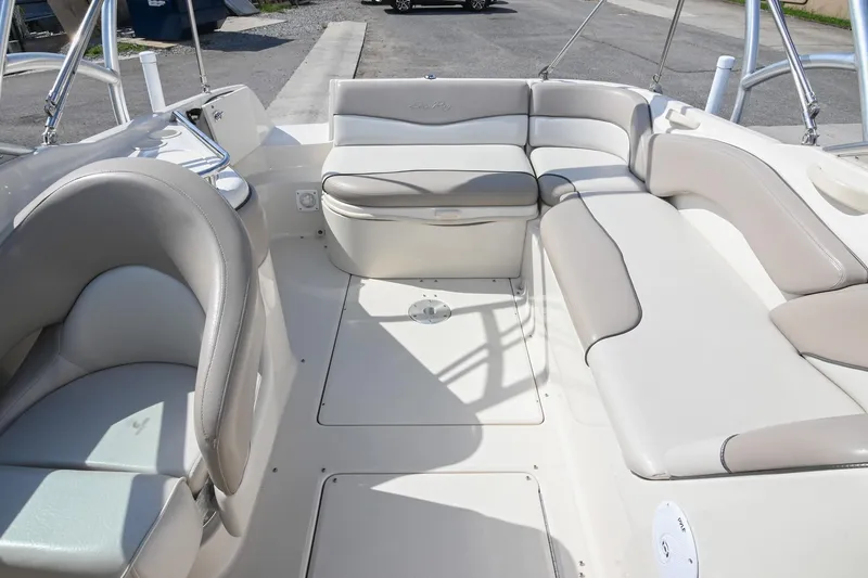 Slide: The Image of 2002 Sea Ray 240 Sundeck interior with spacious seating and sleek design. - 22
