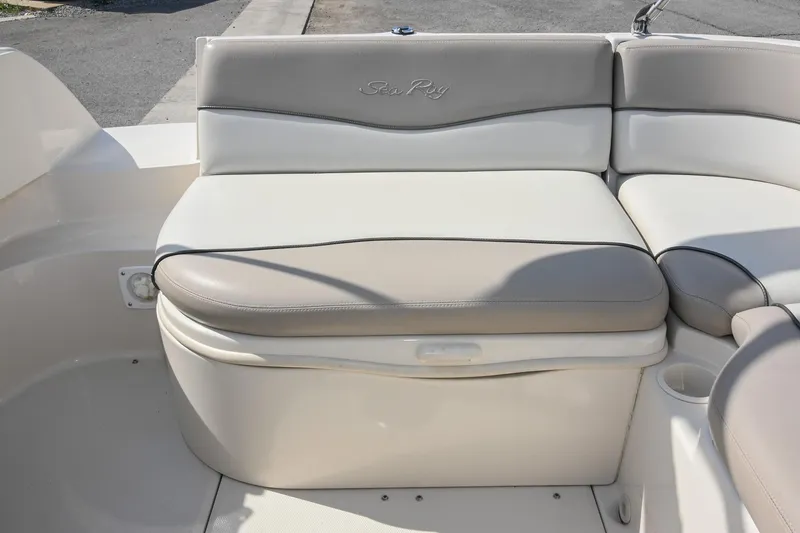 Slide: The Image of 2002 Sea Ray 240 Sundeck boat seating area with beige and white upholstery. - 24