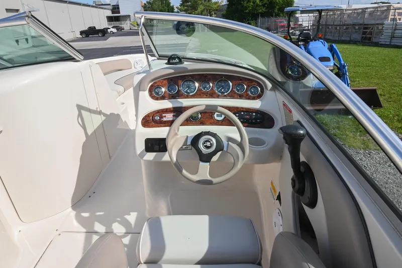 Slide: The Image of Interior view of 2002 Sea Ray 240 Sundeck boat cockpit with steering wheel and dashboard. - 25