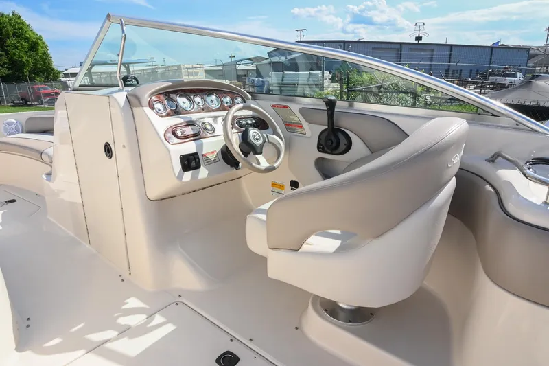 Slide: The Image of 2002 Sea Ray 240 Sundeck boat interior with steering wheel and control panel. - 29