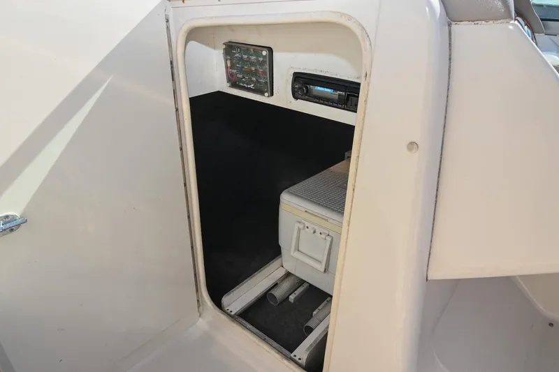 Slide: The Image of Interior storage compartment of a 2002 Sea Ray 240 Sundeck boat with control panel. - 31