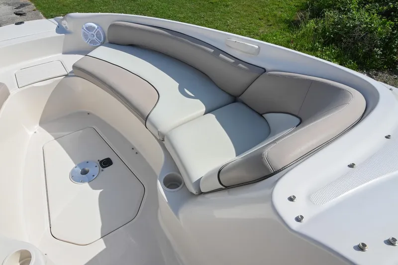 Slide: The Image of 2002 Sea Ray 240 Sundeck boat interior with cushioned seating and speaker. - 33