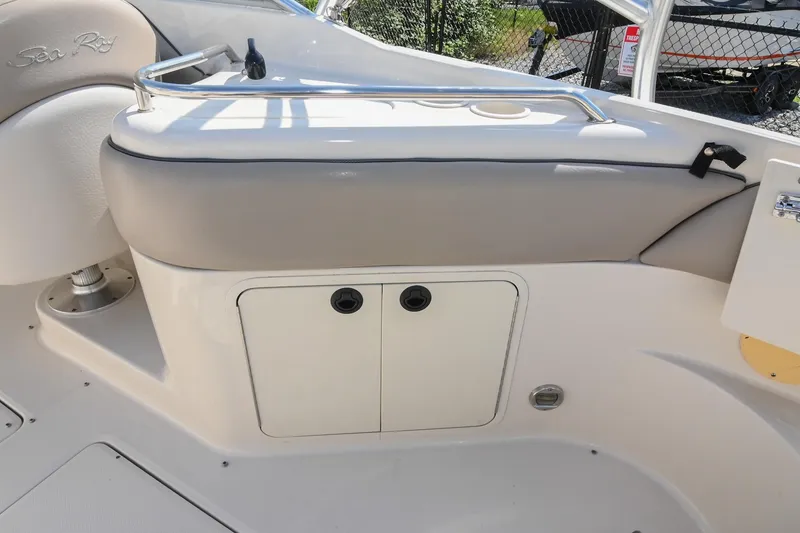 Slide: The Image of 2002 Sea Ray 240 Sundeck interior with storage compartment and seating area. - 38