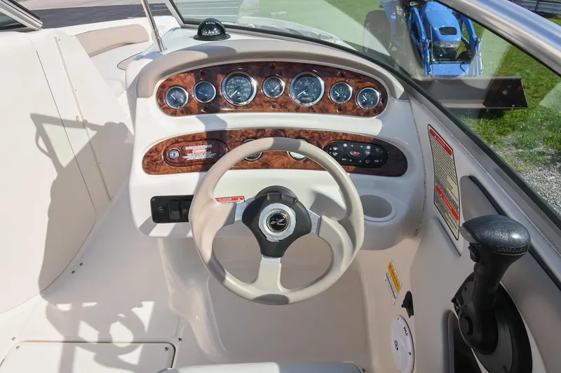 Slide: The Image of Steering console of a 2002 Sea Ray 240 Sundeck boat with gauges and controls. - 39