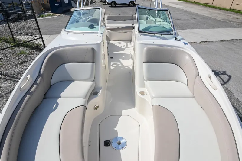 Slide: The Image of 2002 Sea Ray 240 Sundeck boat interior with spacious seating and dual windshields. - 7