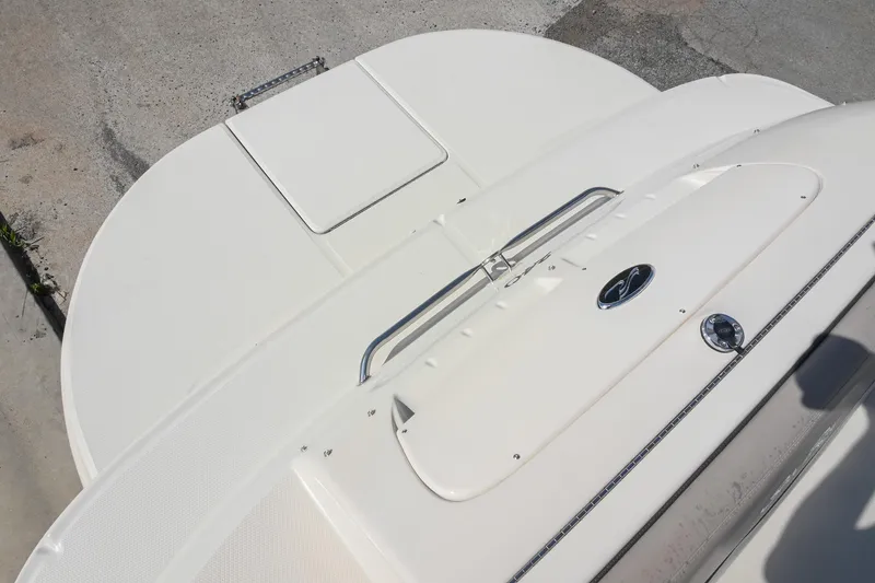 Slide: The Image of 2002 Sea Ray 240 Sundeck boat deck with sleek white finish and chrome details. - 8