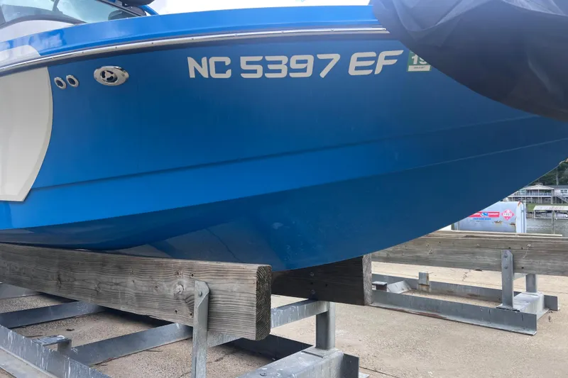 Slide: The Image of 2016 Nautique Super Air Nautique 210 boat on trailer, blue hull, registration NC 5397 EF. - 10